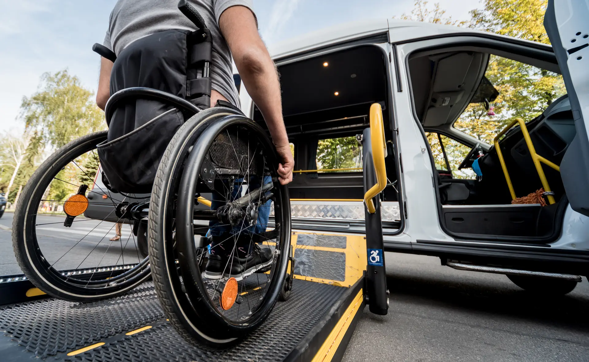 A veteran in a wheelchair using a ramp to board a wheelchair-accessible vehicle, ensuring mobility and independence.