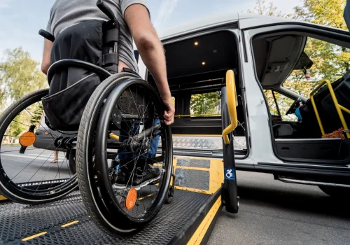 A veteran in a wheelchair using a ramp to board a wheelchair-accessible vehicle, ensuring mobility and independence.